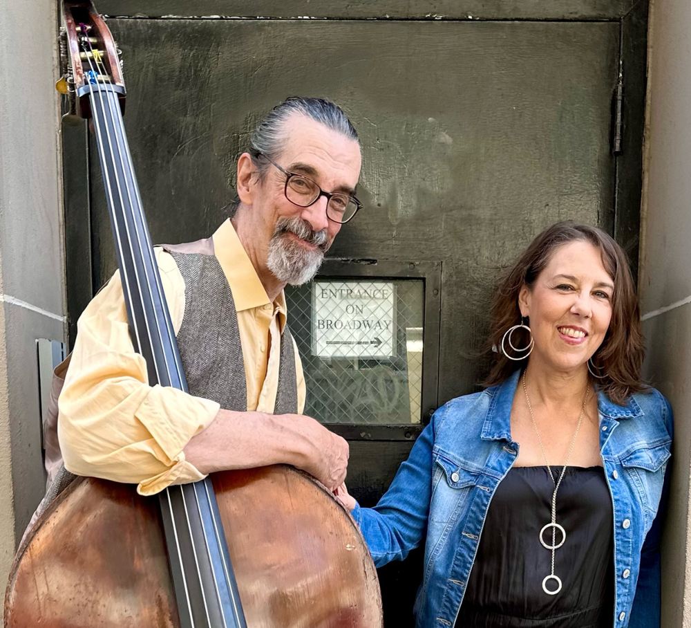 Ritt Henn with his upright bass and Beth Falcone in a doorway on West 79th Street.