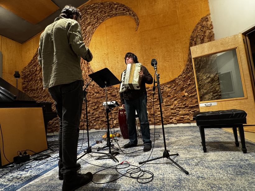 Bob Malone playing accordion in the live room.