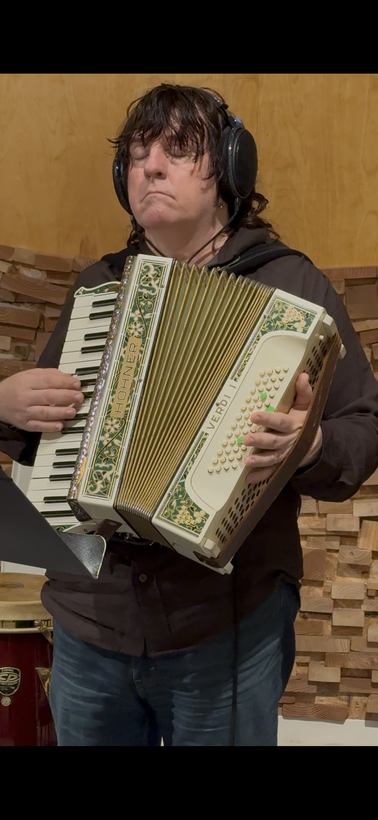 Bob Malone playing accordion in the studio.