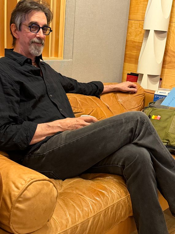 A musician relaxing on a leather couch in the studio lounge.