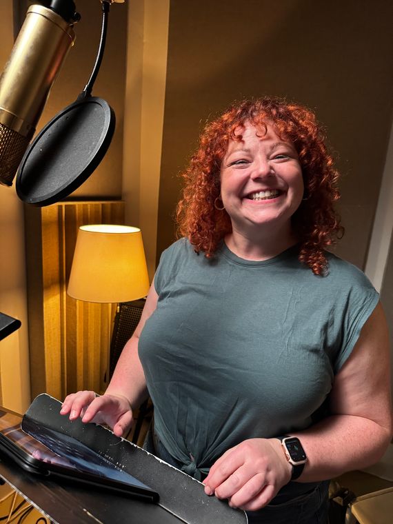 Christine de Frece smiling at the vocal mic.