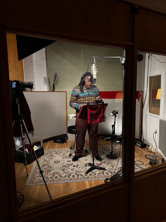 A vocal take seen through the control-room glass.