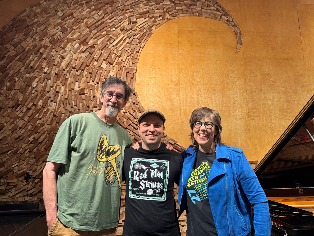 Dennis Lichtman with Beth Falcone and Ritt Henn in front of the studio&rsquo;s wooden wave wall.